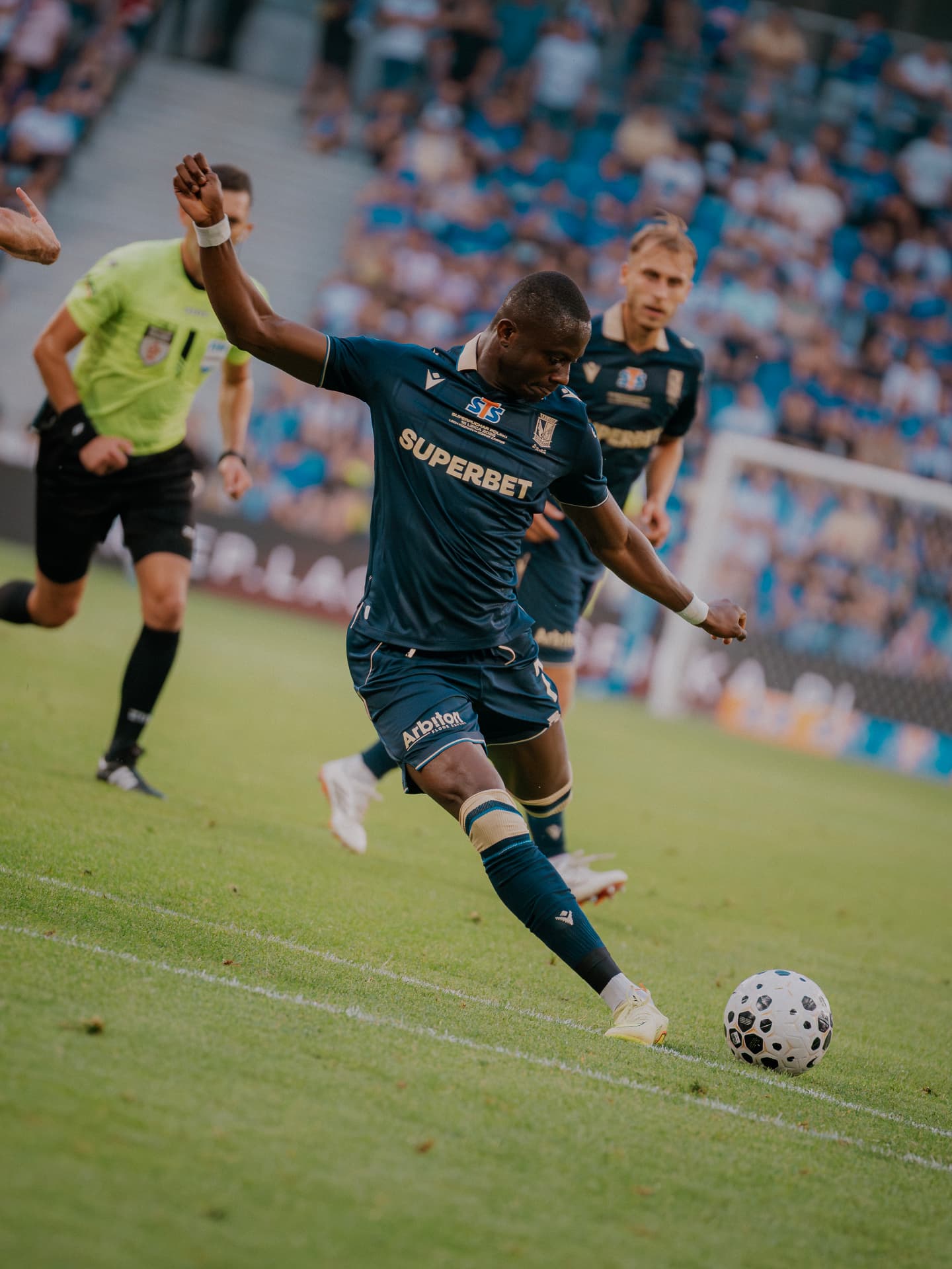Yannick Agnero striking the ball in an Ekstraklasa match